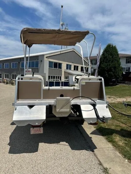 Slide: The Image of 2026 Paddle King Lo Pro Cruiser XL pontoon boat parked on a sunny day. - 4