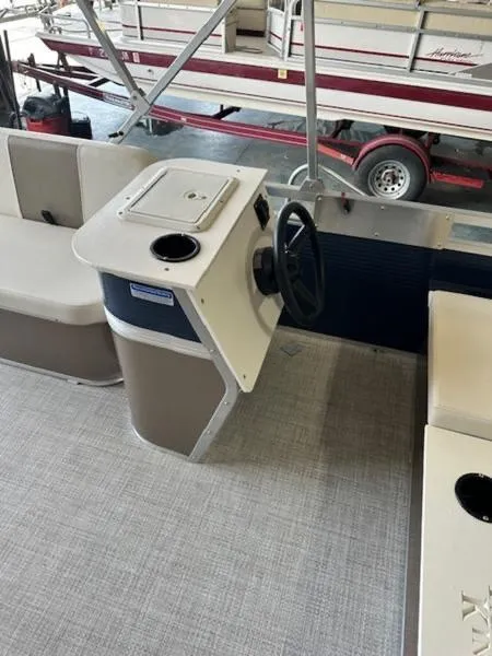 Slide: The Image of 2026 Paddle King Lo Pro Cruiser XL boat interior with steering console and seating. - 5