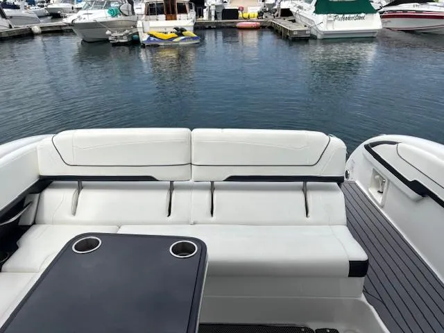 Slide: The Image of 2017 Formula 350 CBR boat interior with white seating and table, docked at marina. - 5