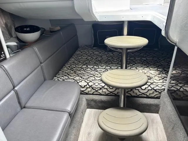 Slide: The Image of 2017 Formula 350 CBR cabin interior with gray seating, patterned bedding, and circular steps. - 8