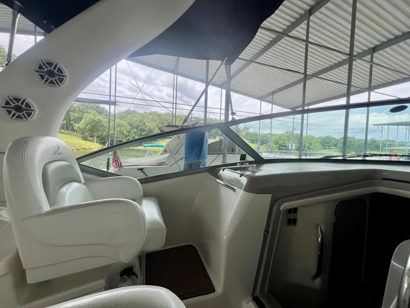 Slide: The Image of Interior view of 2006 Sea Ray 340 Sundancer boat docked under a canopy. - 12