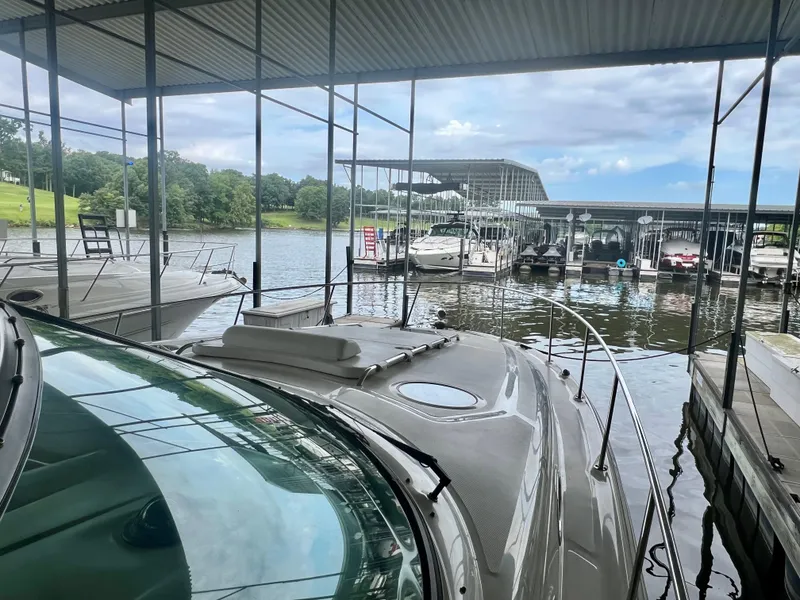 Slide: The Image of 2006 Sea Ray 340 Sundancer docked at a marina under a covered structure. - 14