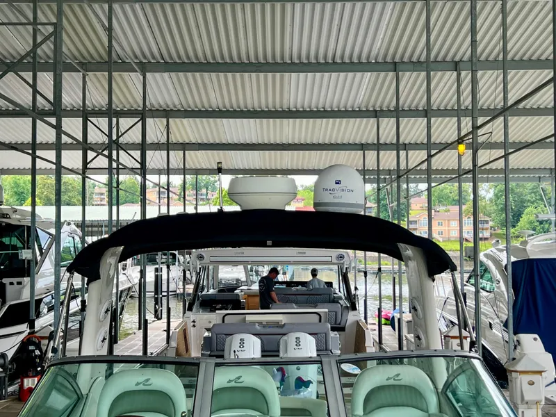 Slide: The Image of 2006 Sea Ray 340 Sundancer docked under covered marina, featuring spacious seating and modern amenities. - 15