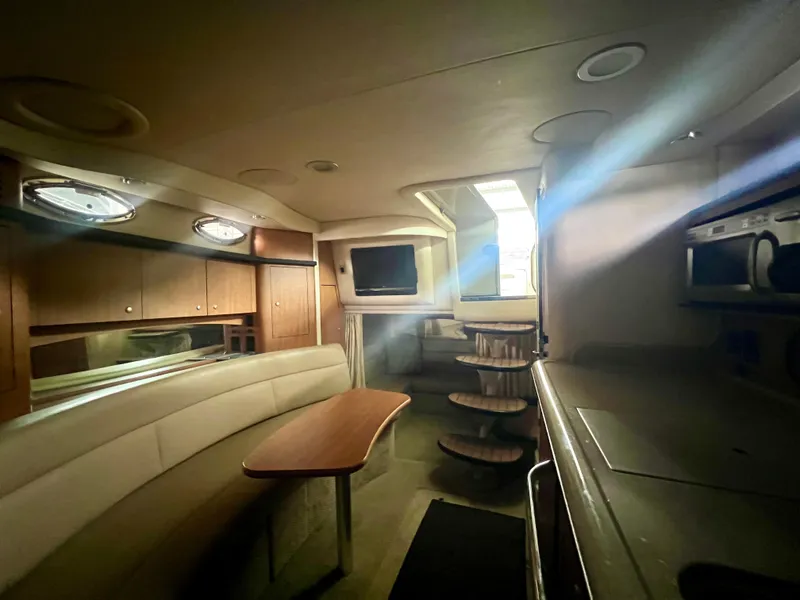 Slide: The Image of Interior of 2006 Sea Ray 340 Sundancer yacht, featuring cozy seating and modern amenities. - 19