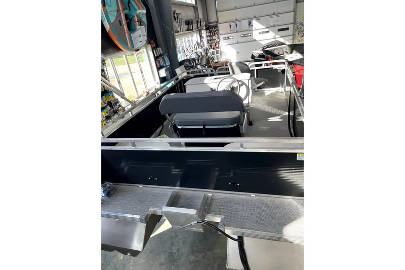 Slide: The Image of 2026 Paddle King LO PRO FISHER boat interior with seating and steering wheel. - 6