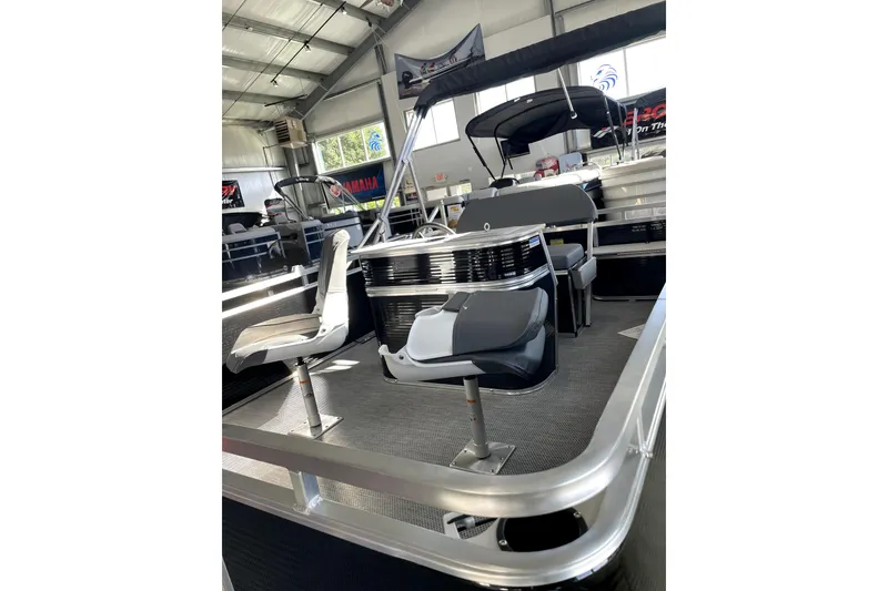Slide: The Image of 2026 Paddle King LO PRO FISHER boat interior with seating in a showroom. - 7