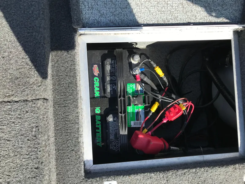 Slide: The Image of Battery compartment of a 2011 Lund 1775 Impact boat, showing wiring and connections. - 10