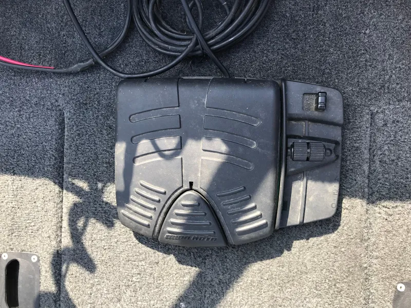 Slide: The Image of Foot pedal control on a 2011 Lund 1775 Impact boat, with coiled cable. - 12