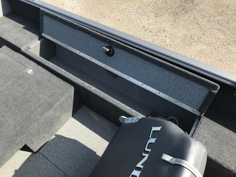Slide: The Image of Interior of a 2011 Lund 1775 Impact boat showing storage compartments and seating. - 14