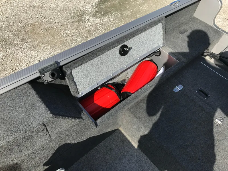 Slide: The Image of 2011 Lund 1775 Impact boat storage compartment with red life jackets inside. - 15