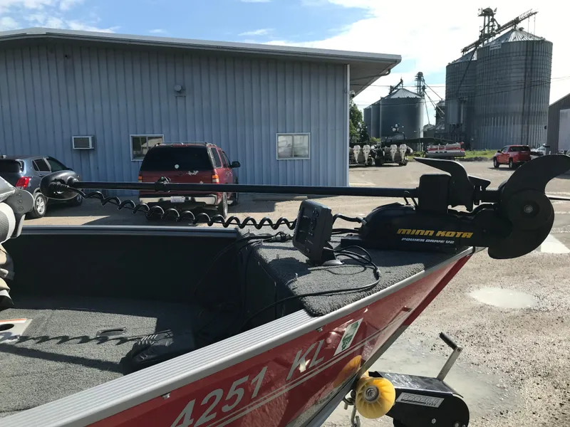 Slide: The Image of 2011 Lund 1775 Impact boat with Minn Kota motor in industrial setting. - 4