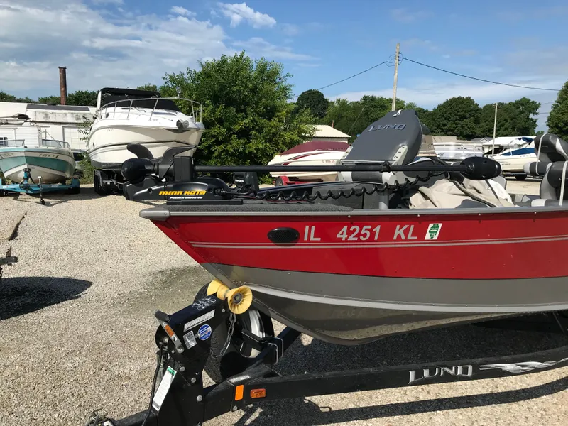 Slide: The Image of 2011 Lund 1775 Impact boat on trailer in a marina setting. - 5