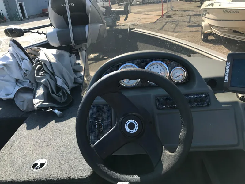 Slide: The Image of 2011 Lund 1775 Impact boat dashboard with steering wheel and gauges. - 9