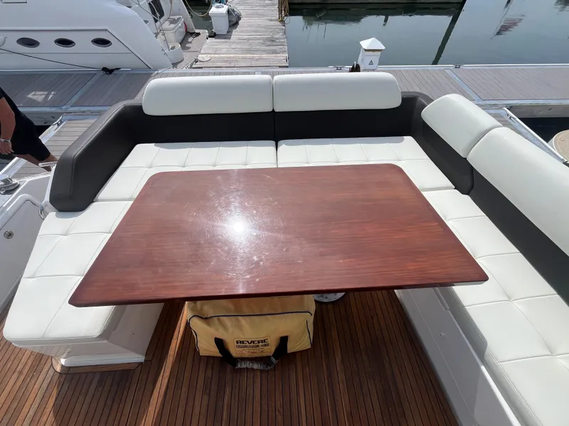 Slide: The Image of Luxurious seating area on a 2014 Azimut 55S yacht with wooden table and cushioned seats. - 10