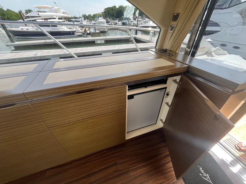 Slide: The Image of Interior of 2014 Azimut 55S yacht with open cabinet and mini fridge. - 15