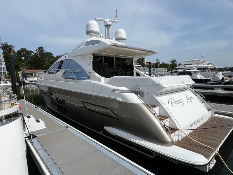 Slide: The Image of 2014 Azimut 55S yacht docked at marina, rear view with "Penny Lane" name. - 4