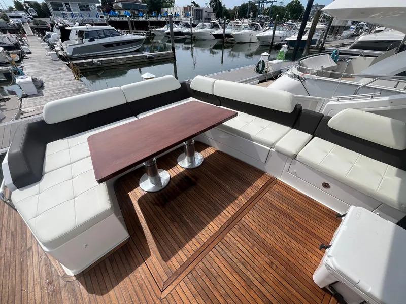 Slide: The Image of Luxurious 2014 Azimut 55S yacht deck with elegant seating and wooden table at marina. - 9