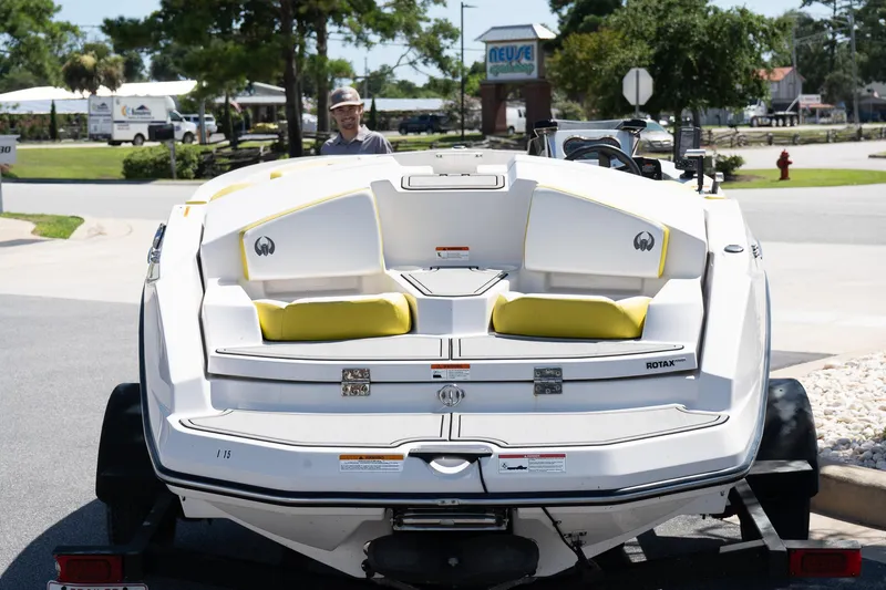 Slide: The Image of 2017 Scarab 165 G boat on trailer, featuring white and yellow seating. - 4