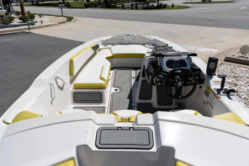 Slide: The Image of 2017 Scarab 165 G boat interior with yellow seating and modern dashboard controls. - 7