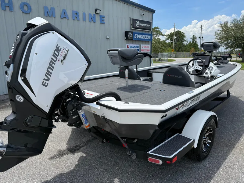 Slide: The Image of 2018 Vexus AVX 1980 boat with Evinrude engine, parked outside a marine shop. - 12