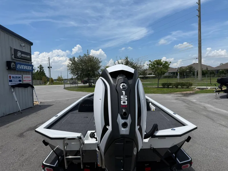 Slide: The Image of 2018 Vexus AVX 1980 boat with 150 HP engine, parked near marine dealership. - 13
