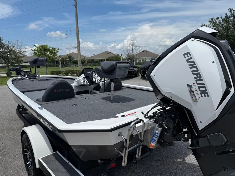 Slide: The Image of 2018 Vexus AVX 1980 boat with Evinrude engine, parked outdoors on a sunny day. - 14