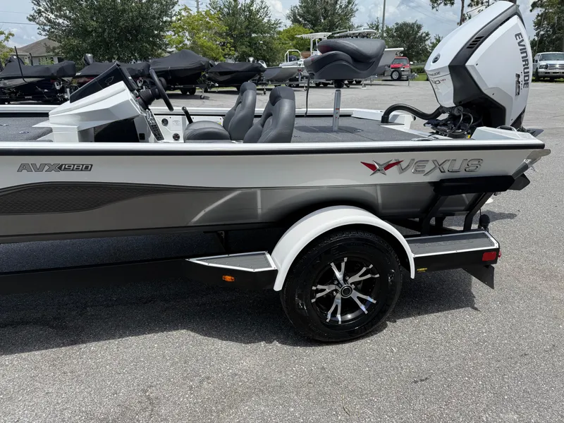 Slide: The Image of 2018 Vexus AVX 1980 boat with Evinrude engine, parked on a trailer. - 4