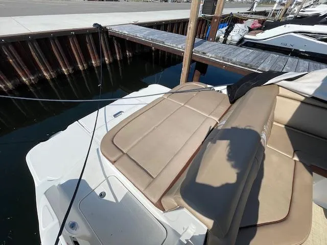 Slide: The Image of 2017 Sea Ray SDX 270 boat with tan seating docked at marina. - 2
