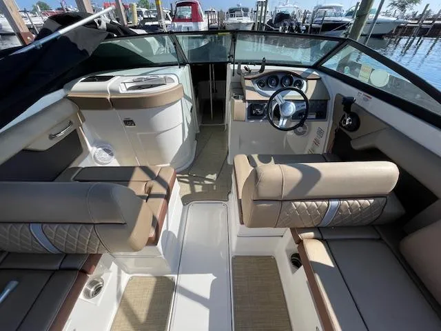 Slide: The Image of 2017 Sea Ray SDX 270 boat interior with beige seating and modern dashboard. - 3