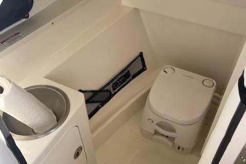 Slide: The Image of 2017 Sea Ray SDX 270 boat interior with compact toilet and sink. - 5