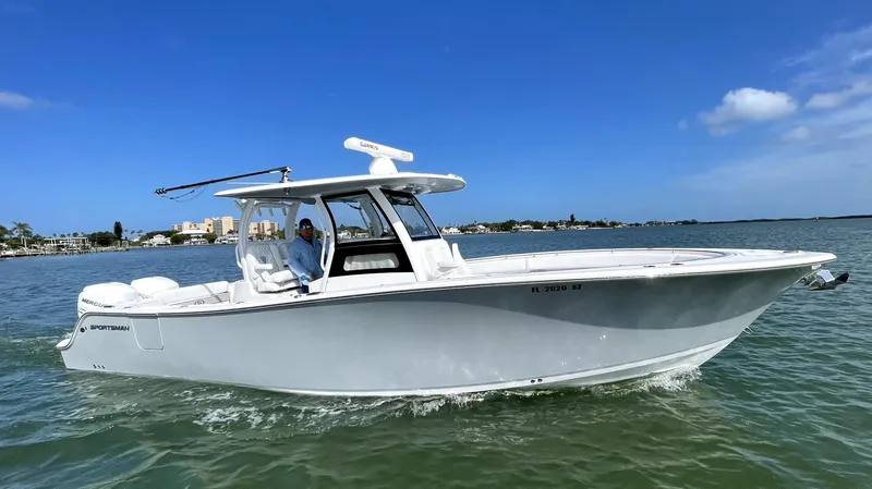 The Image of 2021 Sportsman Open 322 Center Console boat cruising on a sunny day. - 0