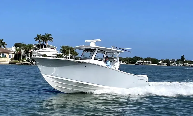 Slide: The Image of 2021 Sportsman Open 322 Center Console boat cruising on a sunny day. - 39