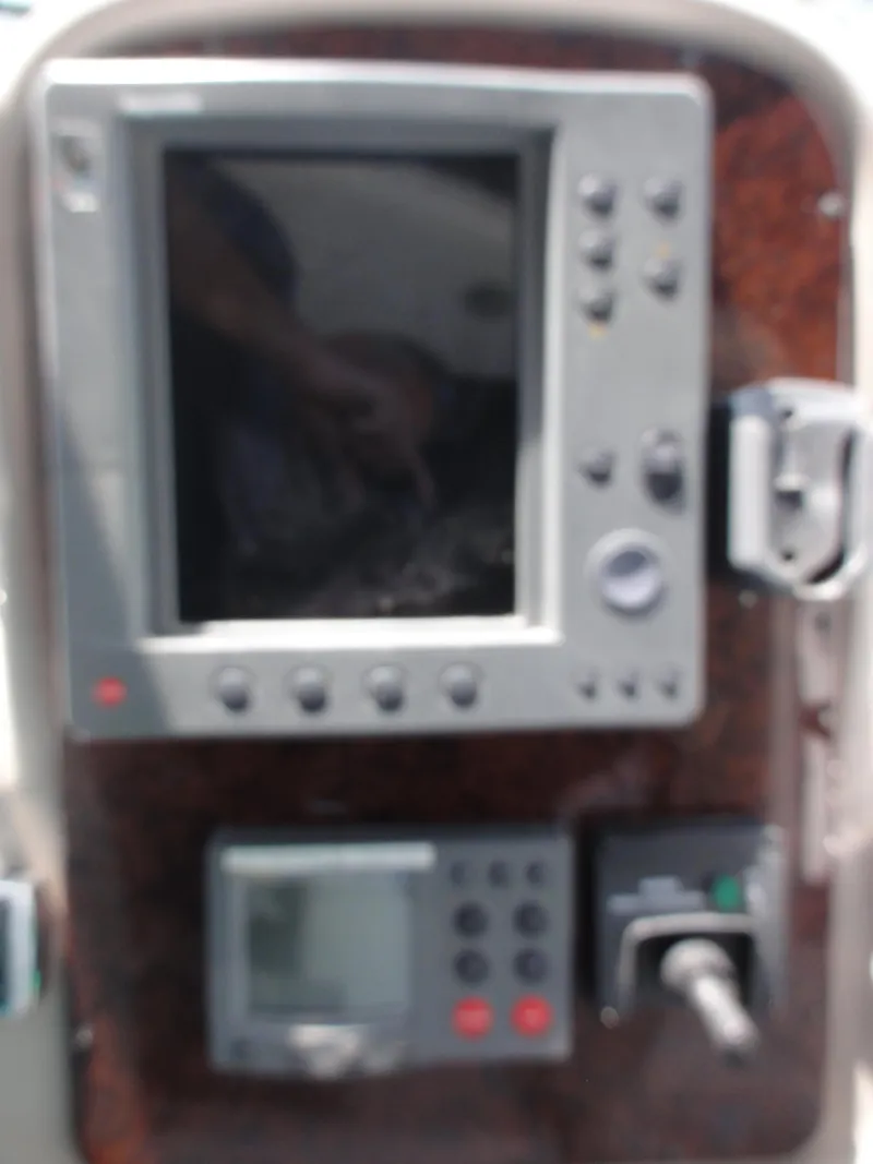 Slide: The Image of Control panel of a 2003 Sea Ray 380 Sundancer boat with navigation equipment. - 13