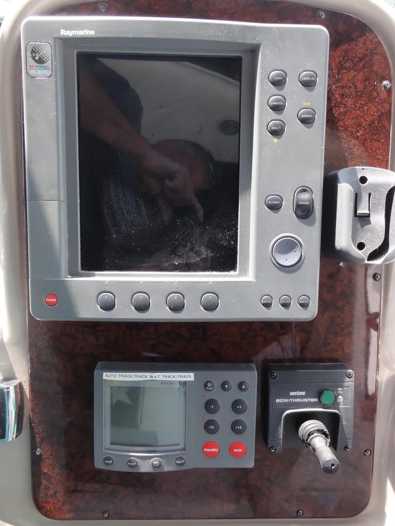 Slide: The Image of Control panel of a 2003 Sea Ray 380 Sundancer boat with navigation equipment. - 14