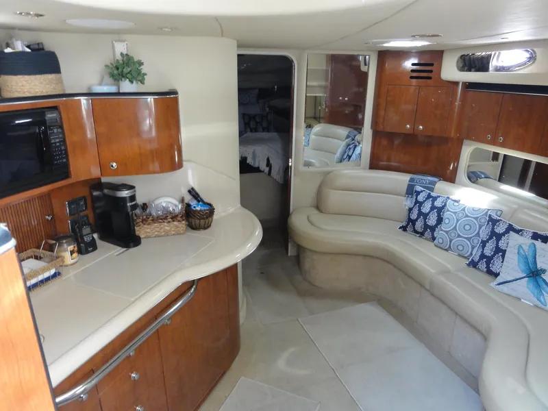 Slide: The Image of Interior of 2003 Sea Ray 380 Sundancer yacht with kitchen and seating area. - 20