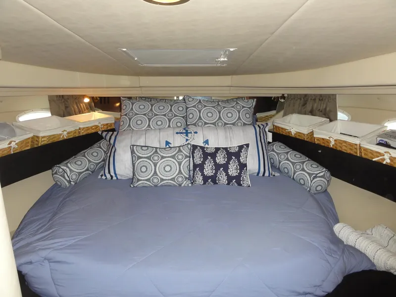 Slide: The Image of Cozy cabin interior of 2003 Sea Ray 380 Sundancer with decorative pillows and bedding. - 26