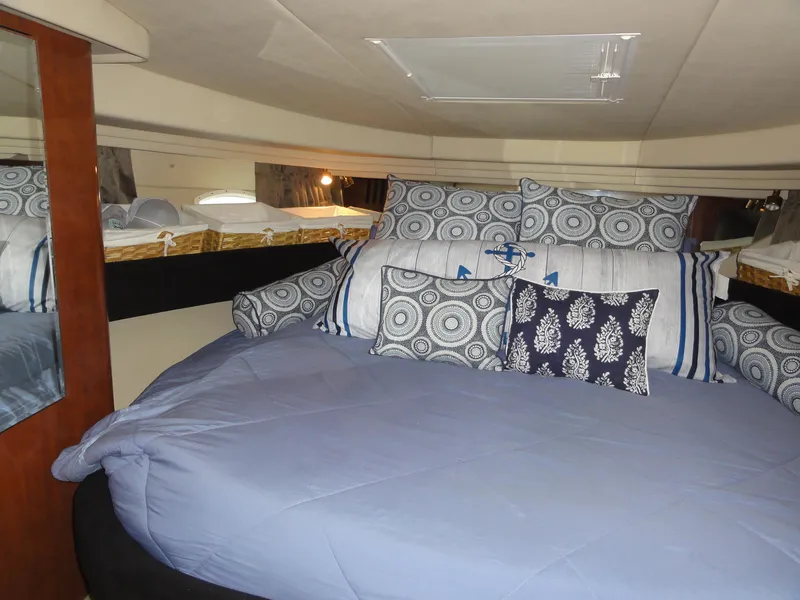 Slide: The Image of Luxurious cabin interior of 2003 Sea Ray 380 Sundancer with plush bedding and decorative pillows. - 28
