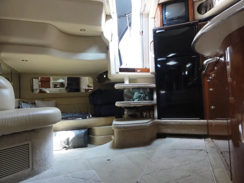 Slide: The Image of Interior of 2003 Sea Ray 380 Sundancer yacht with seating, fridge, and stairs. - 29