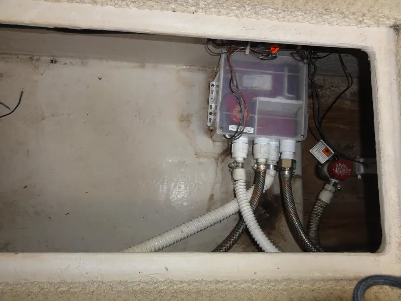 Slide: The Image of Electrical compartment of a 2003 Sea Ray 380 Sundancer boat, showing wiring and connections. - 31