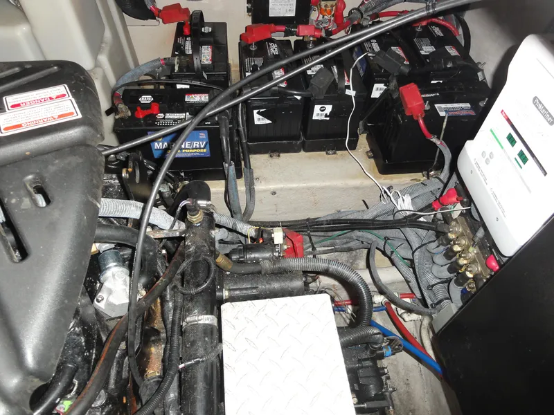 Slide: The Image of Engine compartment of a 2003 Sea Ray 380 Sundancer with batteries and wiring. - 36