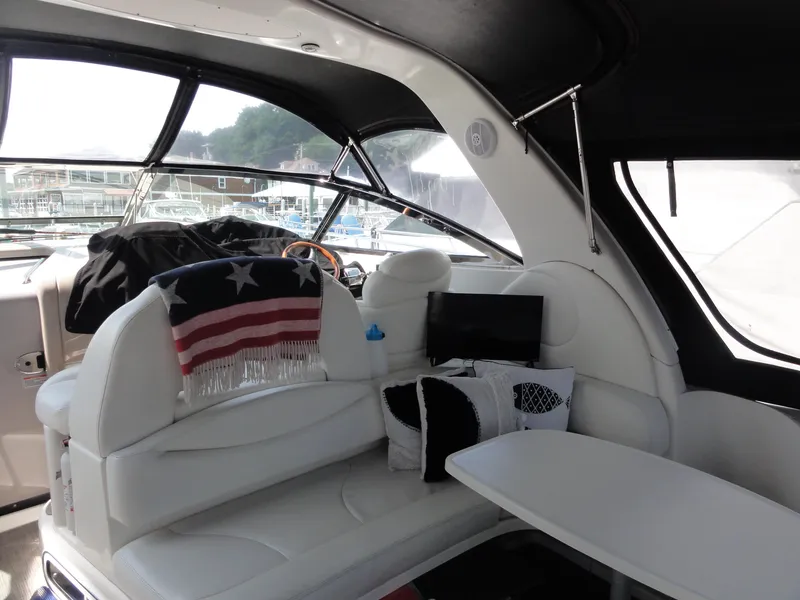 Slide: The Image of Interior of 2003 Sea Ray 380 Sundancer yacht with white seating and small TV. - 7