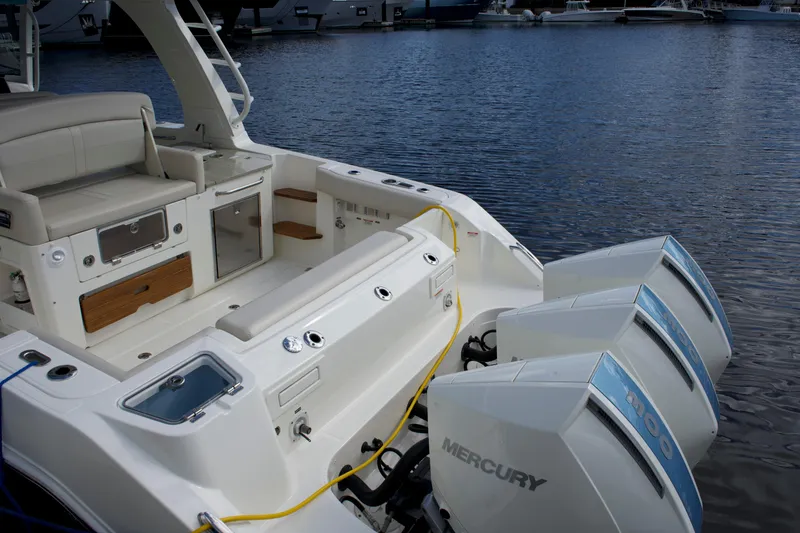Slide: The Image of 2020 Boston Whaler 350 Realm boat with Mercury engines docked at marina. - 27