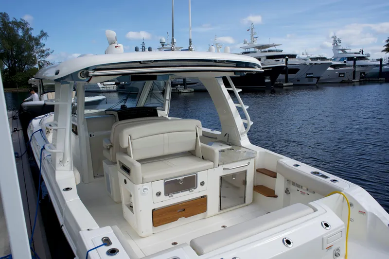 Slide: The Image of 2020 Boston Whaler 350 Realm boat docked, featuring spacious seating and modern amenities. - 29