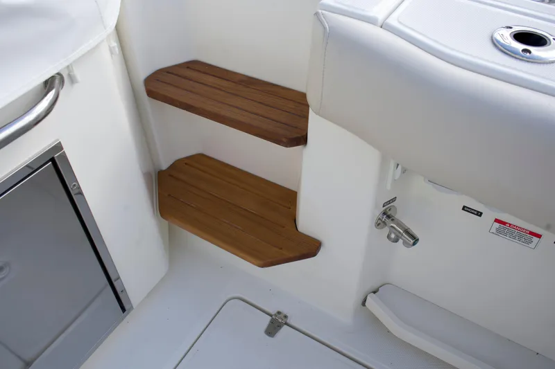 Slide: The Image of Wooden steps on a 2020 Boston Whaler 350 Realm boat interior. - 33