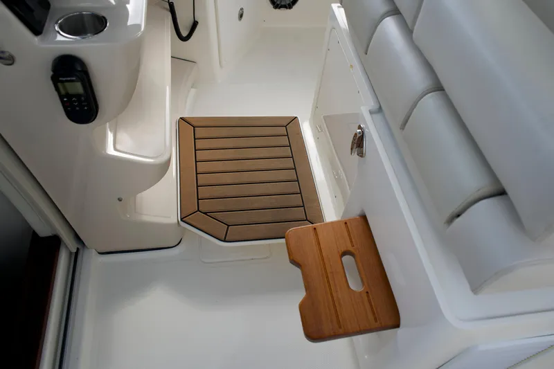 Slide: The Image of Interior of 2020 Boston Whaler 350 Realm, featuring seating and wooden step detail. - 39