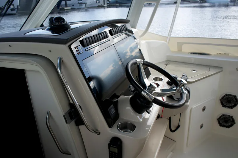 Slide: The Image of 2020 Boston Whaler 350 Realm helm with modern controls and steering wheel. - 40