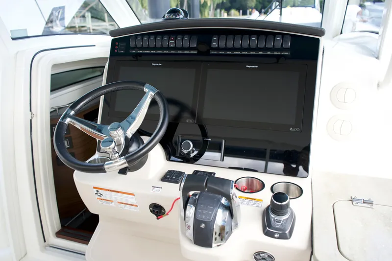 Slide: The Image of 2020 Boston Whaler 350 Realm helm with dual displays and modern controls. - 42