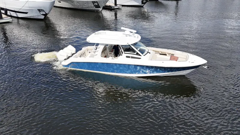 Slide: The Image of 2020 Boston Whaler 350 Realm cruising on calm waters near docked boats. - 5