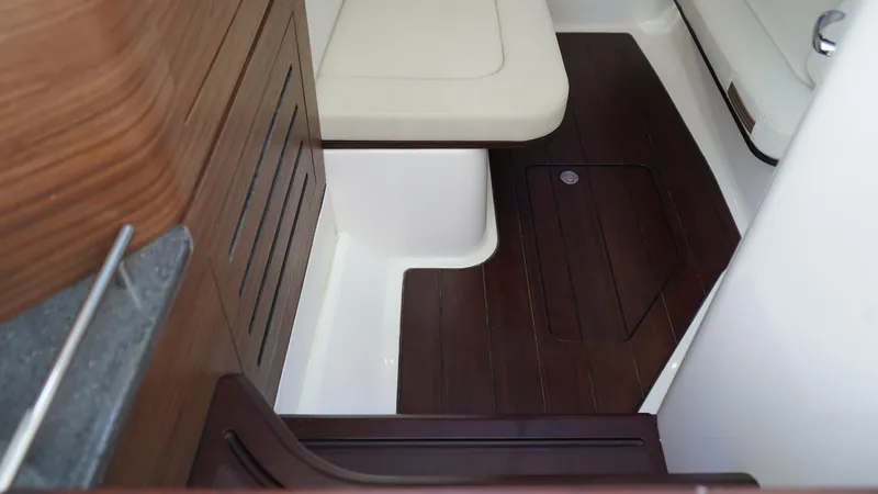 Slide: The Image of 2020 Boston Whaler 350 Realm interior with wood accents and cushioned seating. - 52