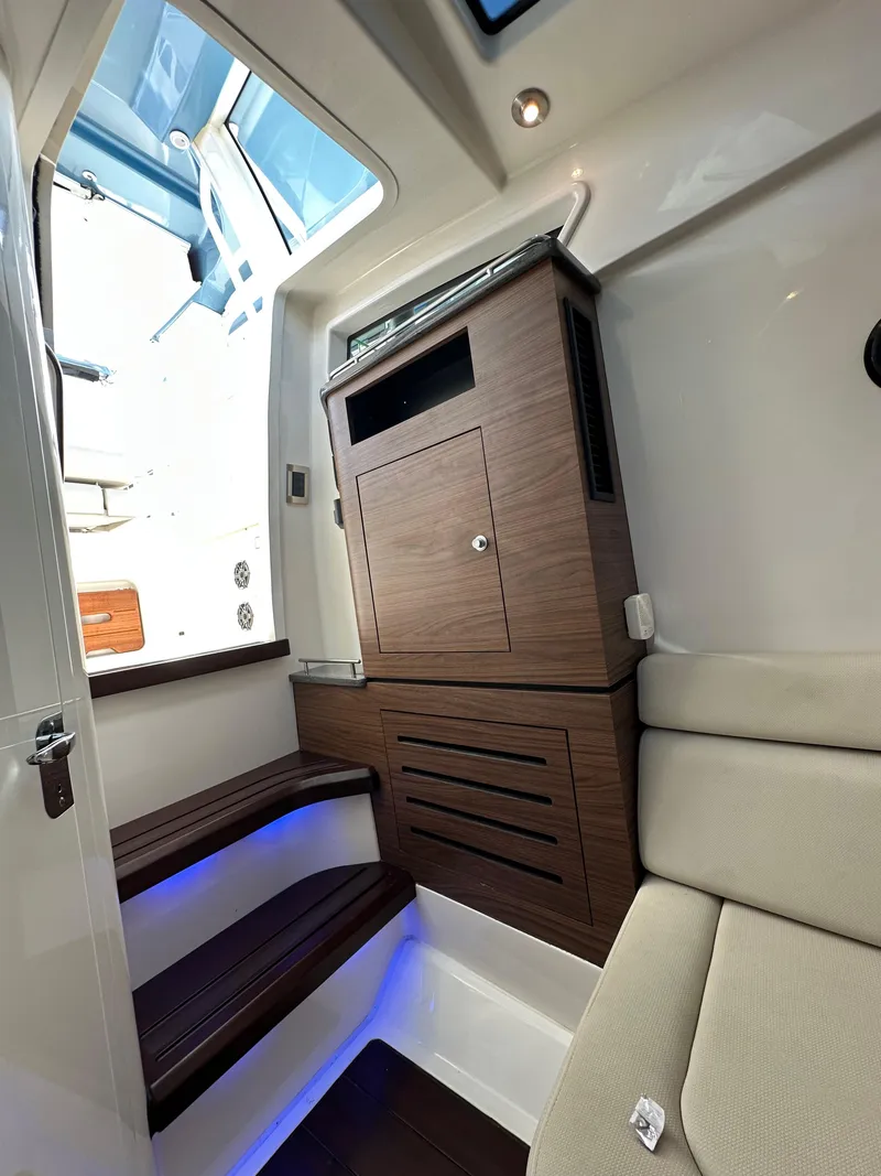 Slide: The Image of Interior of 2020 Boston Whaler 350 Realm with wooden cabinetry and cushioned seating. - 53